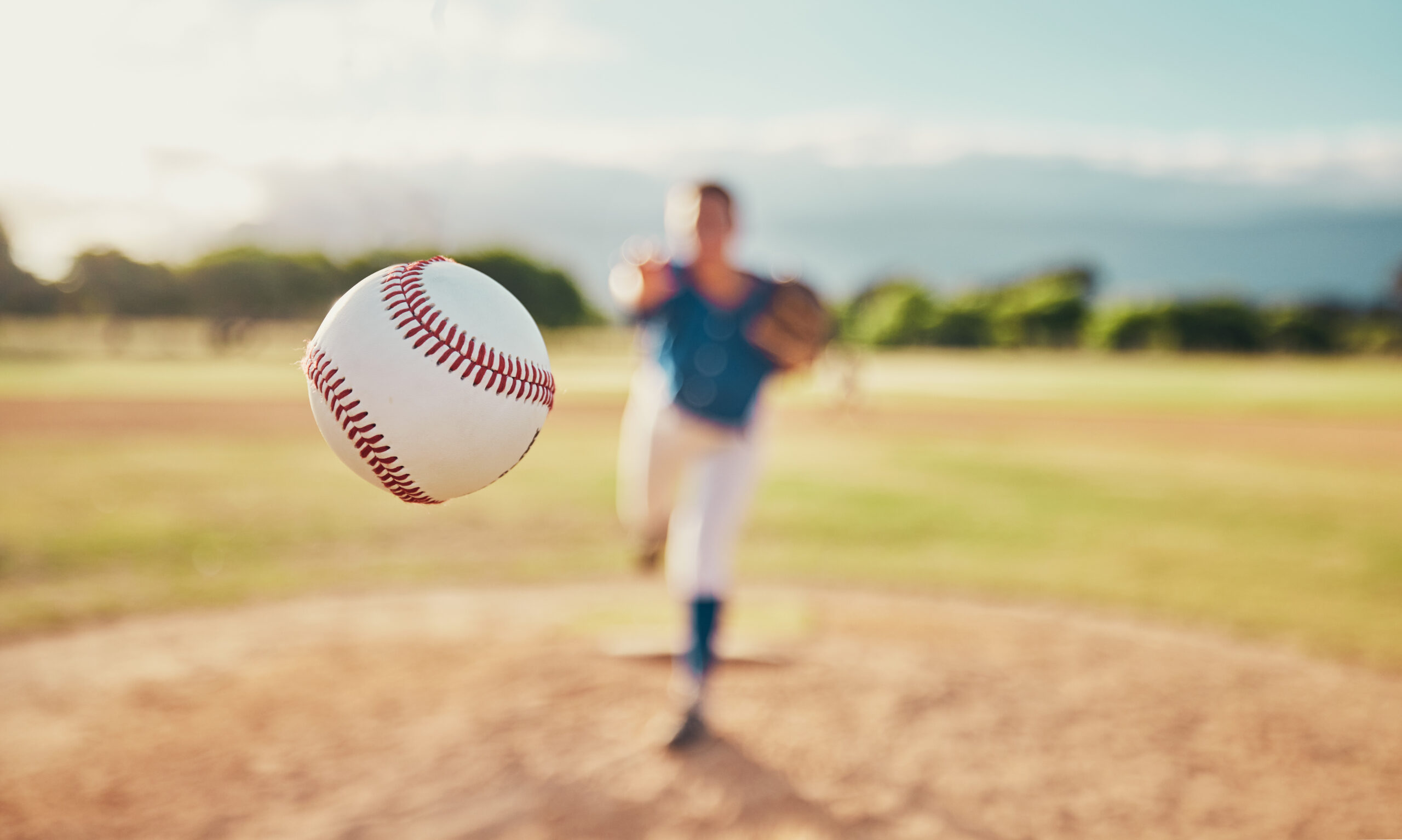 Baseball in motion with pitcher on the mound during training session — TrackMan™ analytics ready to capture velocity, spin rate, and accuracy