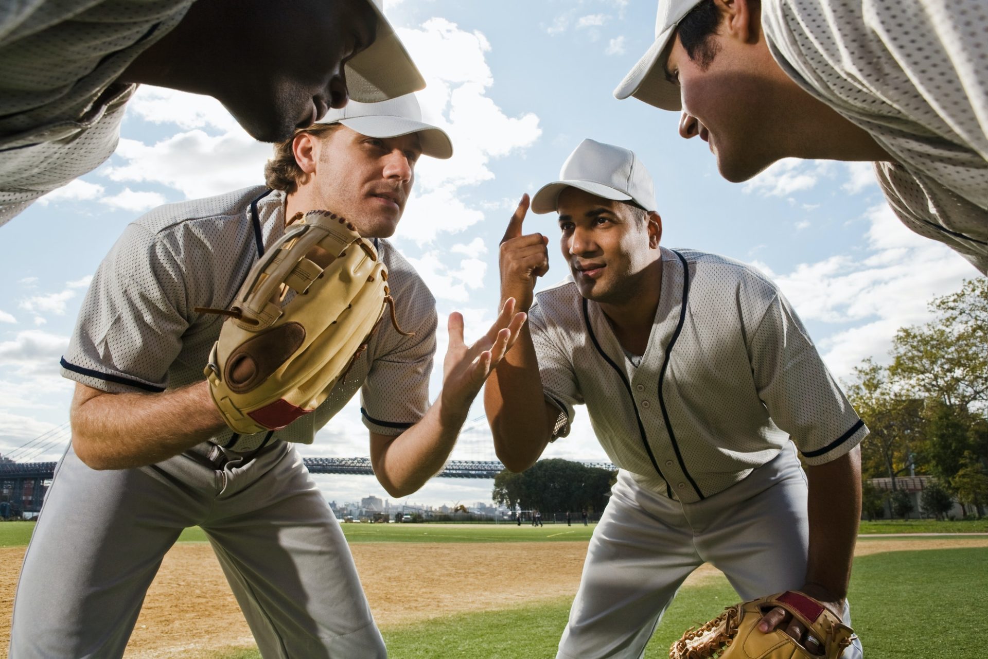 Baseball players preparing for training with TrackMan™ analytics, showcasing teamwork and readiness.